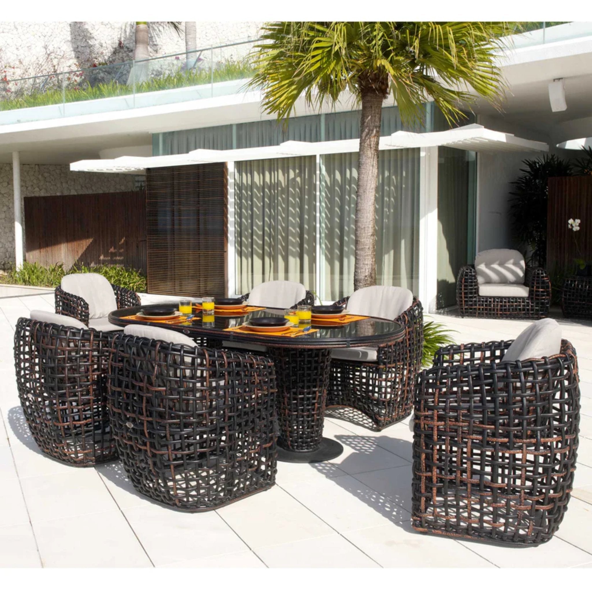 Skyline Design Dynasty 7-piece outdoor dining set with oval table and six chairs, weather-resistant outdoor furniture.