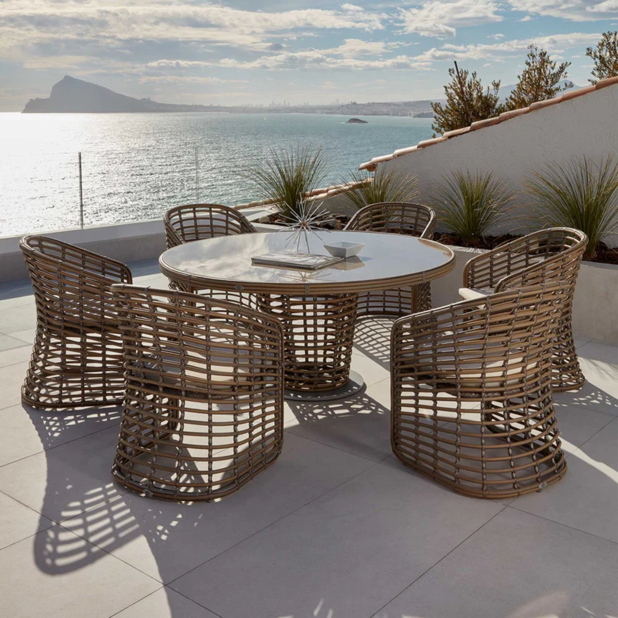 Skyline Design Ruby 7-piece outdoor dining set with round table and six chairs, stylish outdoor furniture for patio dining.