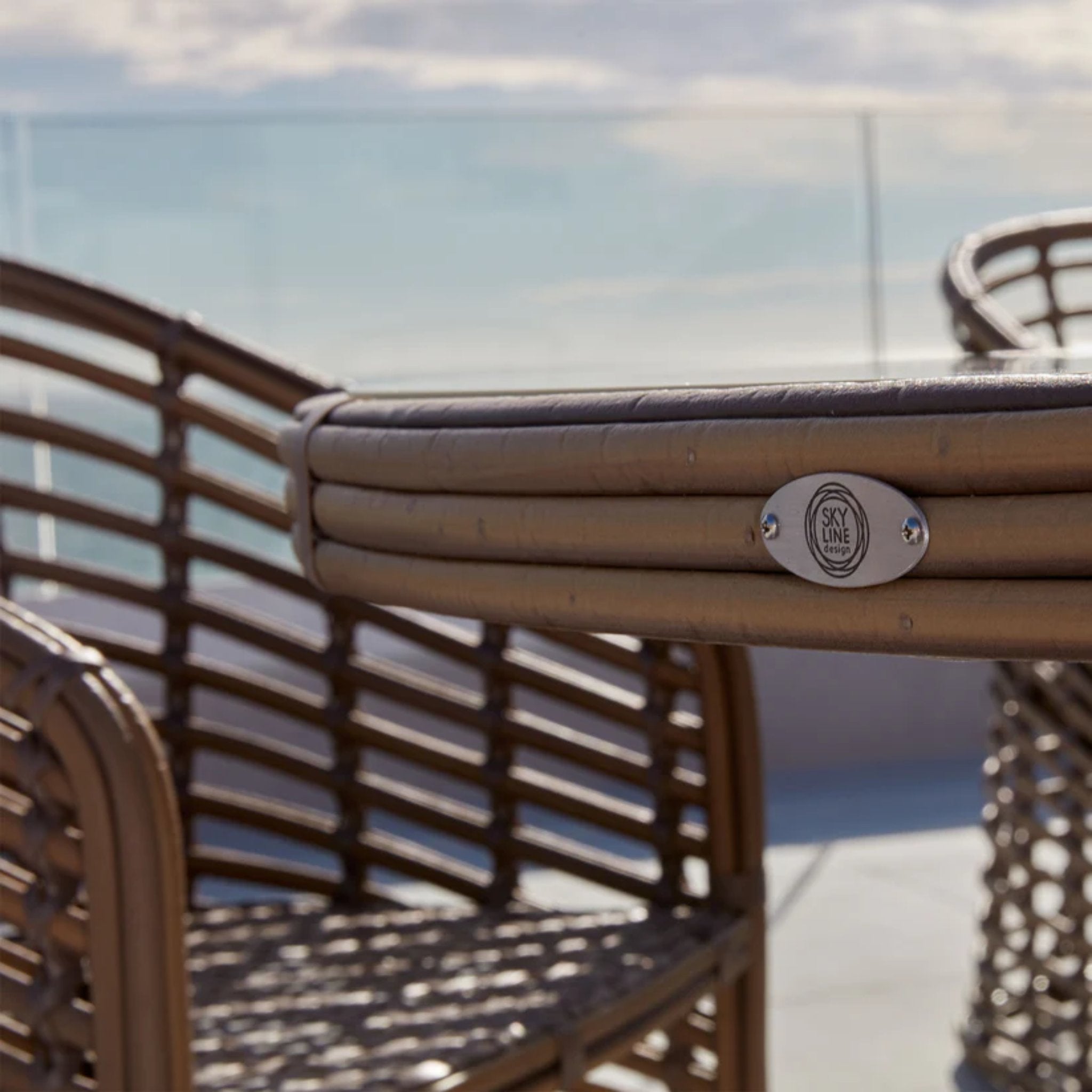 Skyline Design Ruby 7-piece outdoor dining set with round table and six chairs, featuring modern outdoor furniture design.