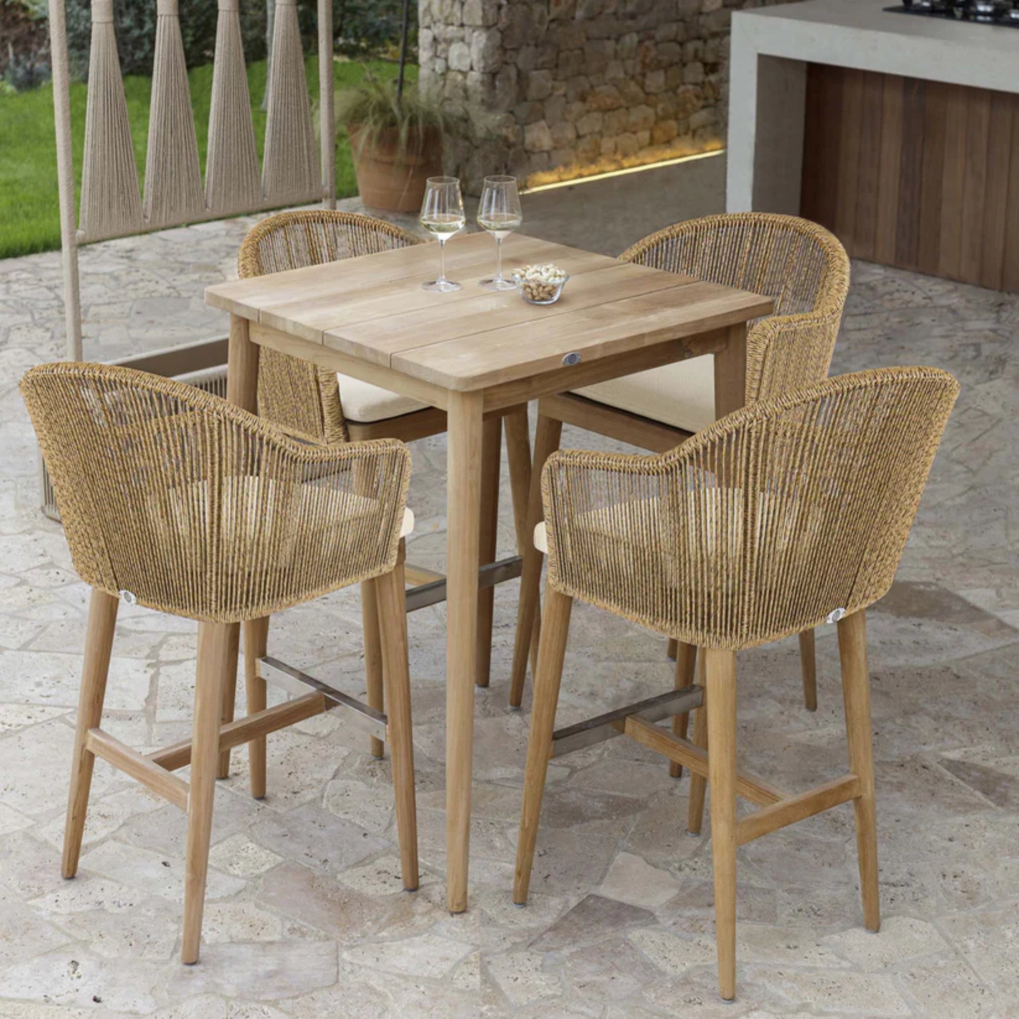 Skyline Design Calixto 5-piece outdoor pub set with teak finish, including a pub table and four matching barstools.