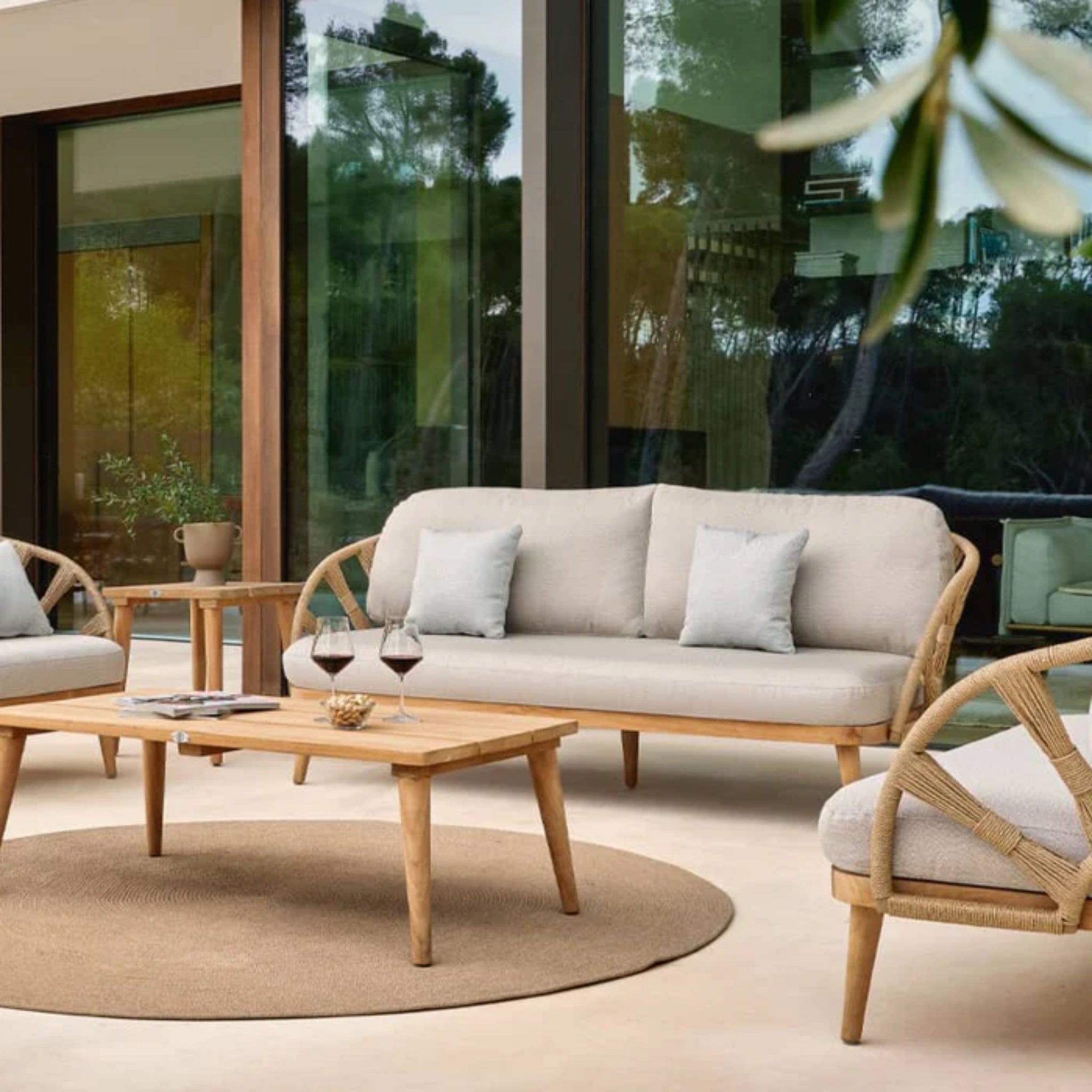 Skyline Design Krabi outdoor lounge set with sofas, chairs, and teak tables, featuring natural rope accents for stylish outdoor seating.