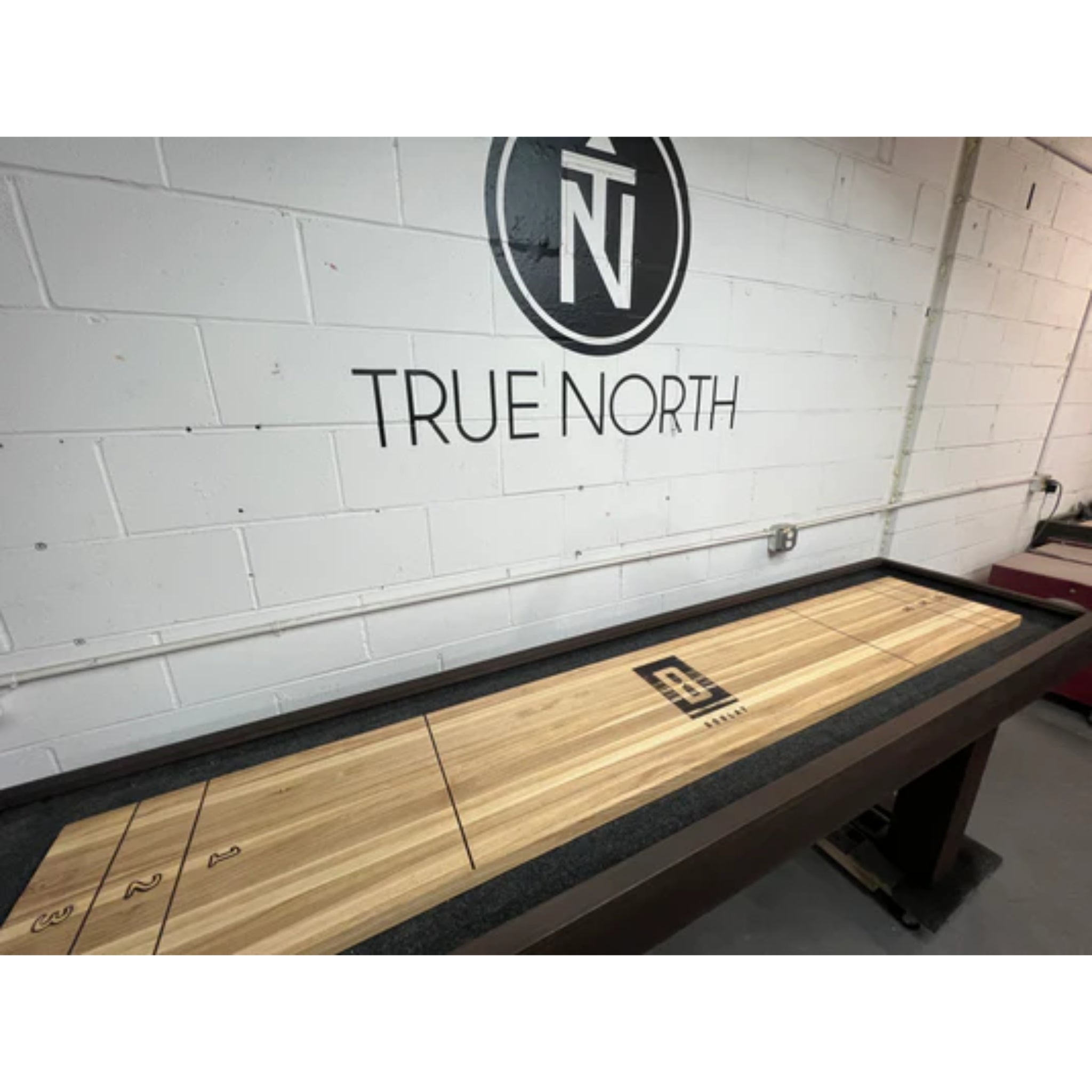True North handcrafted hardwood shuffleboard table with dark espresso finish and H-style playing surface for classic game play.