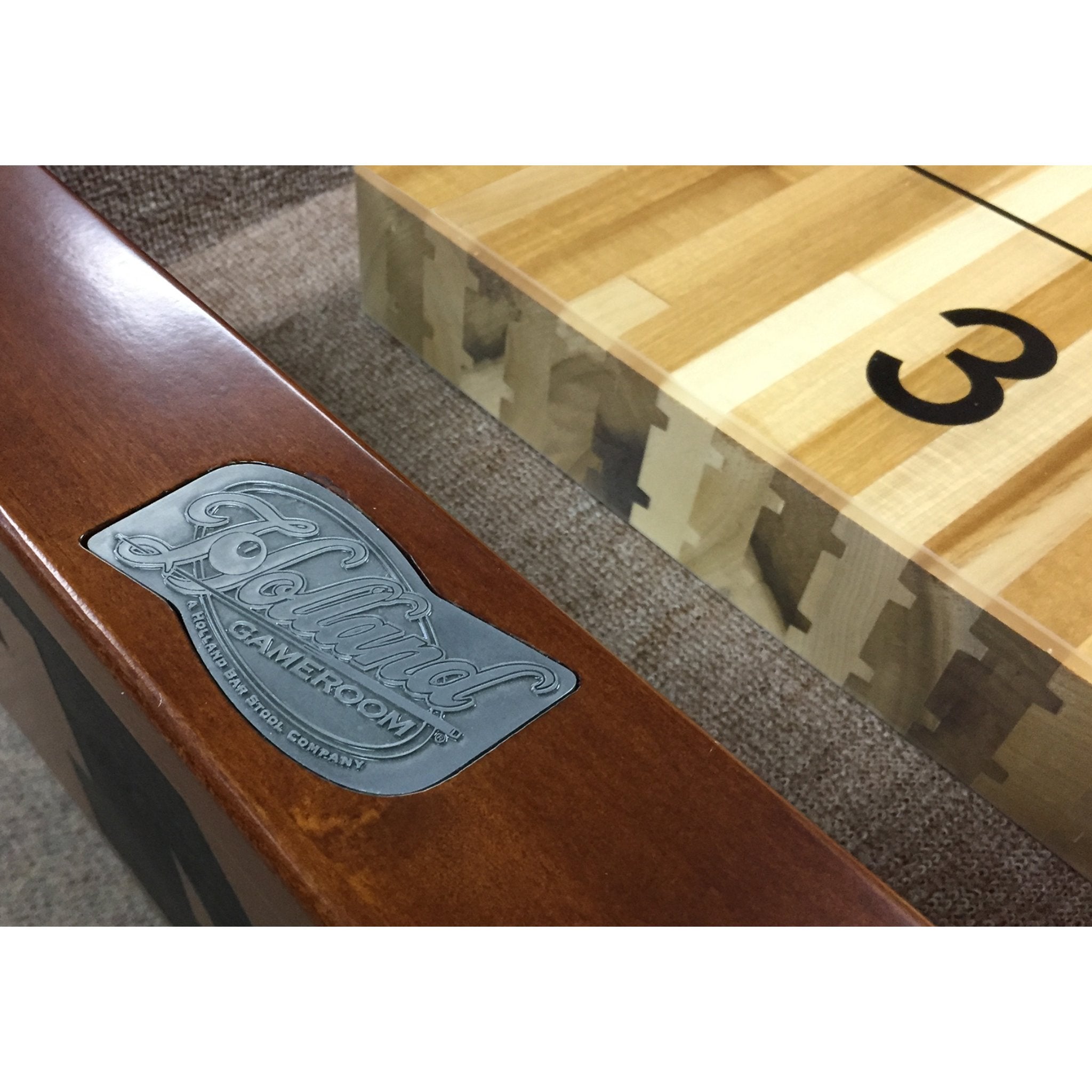 Holland Bar Stool 12 ft official logo shuffleboard table with custom sports logo on the playfield side.