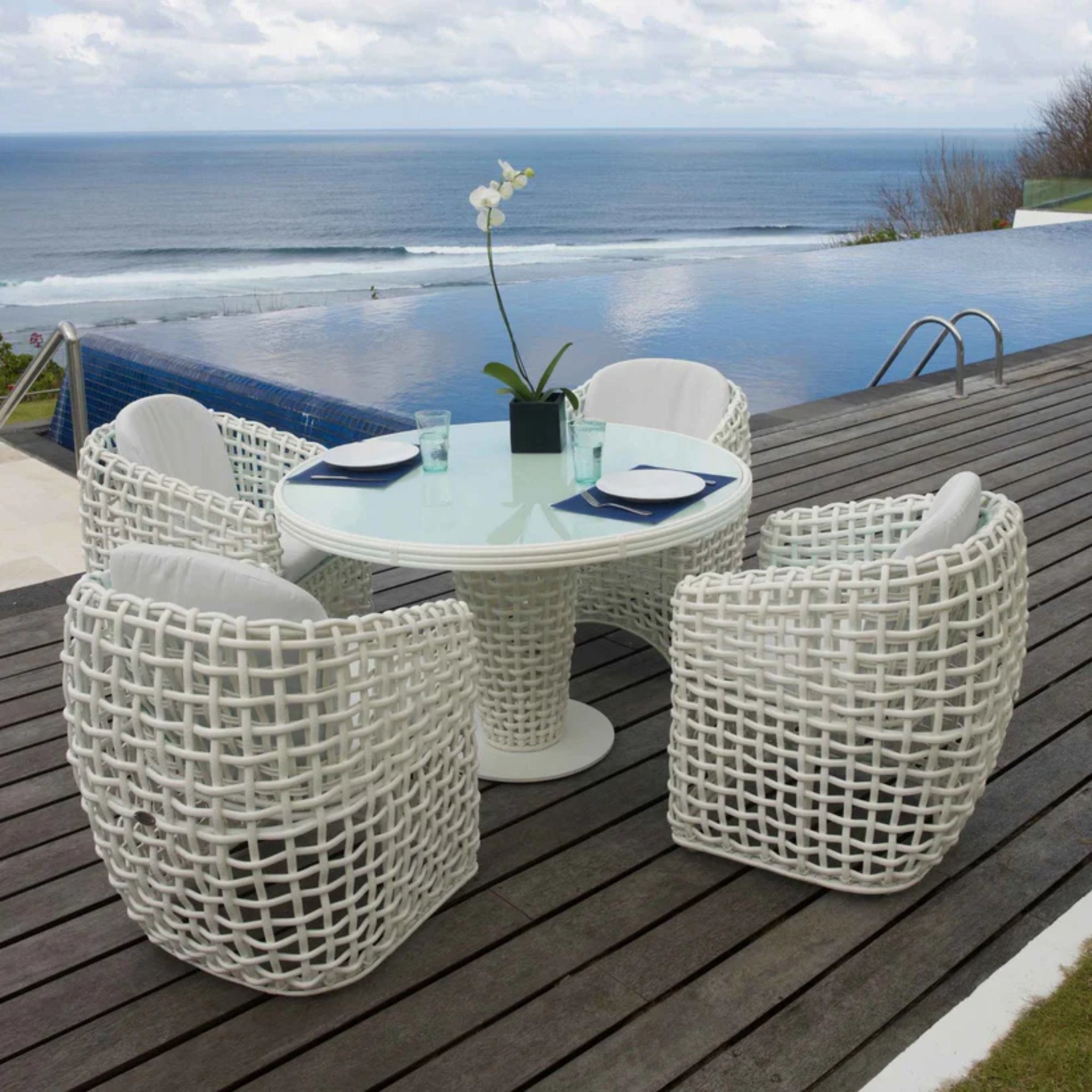 Skyline Design Dynasty 5-Piece Outdoor Dining Set with round table and four chairs in a modern outdoor patio setting.