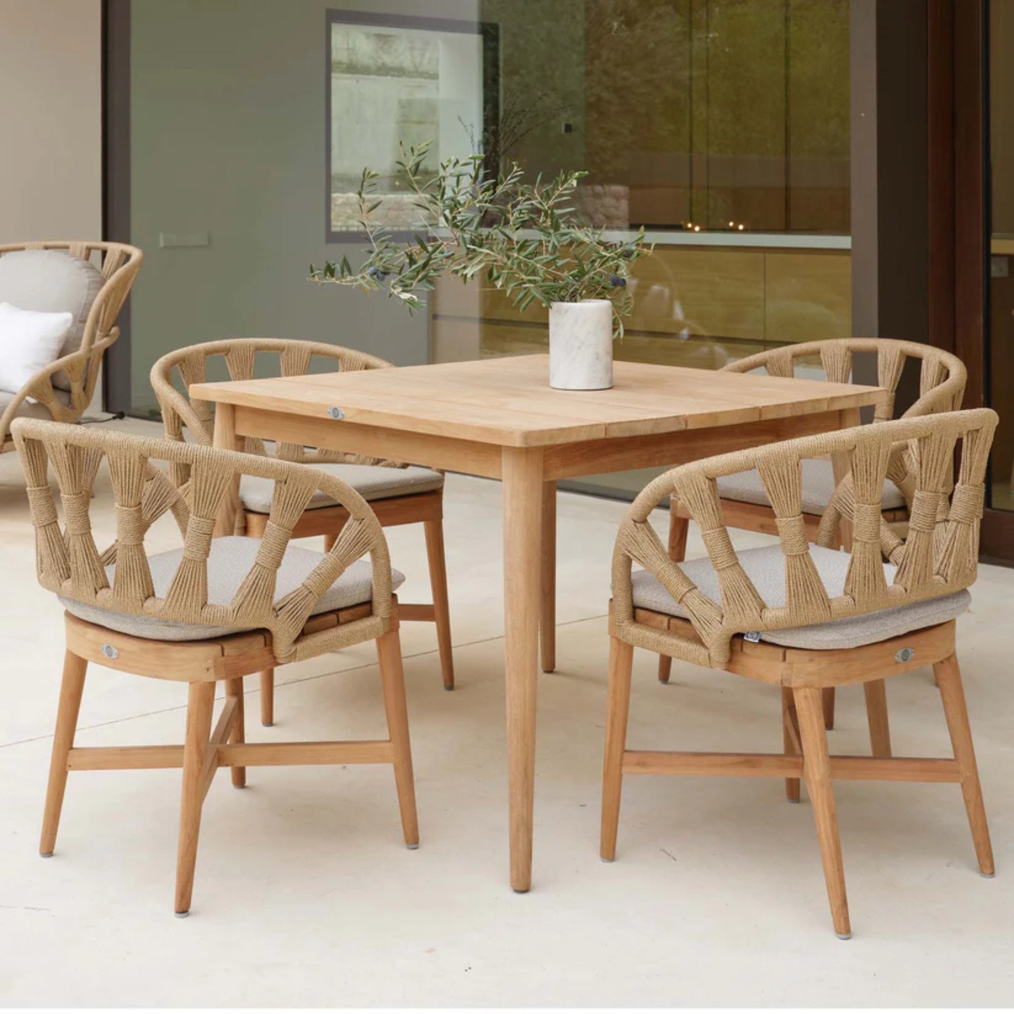 Skyline Design Krabi 5-piece outdoor dining set with square teak table and four matching chairs, ideal for outdoor dining spaces.