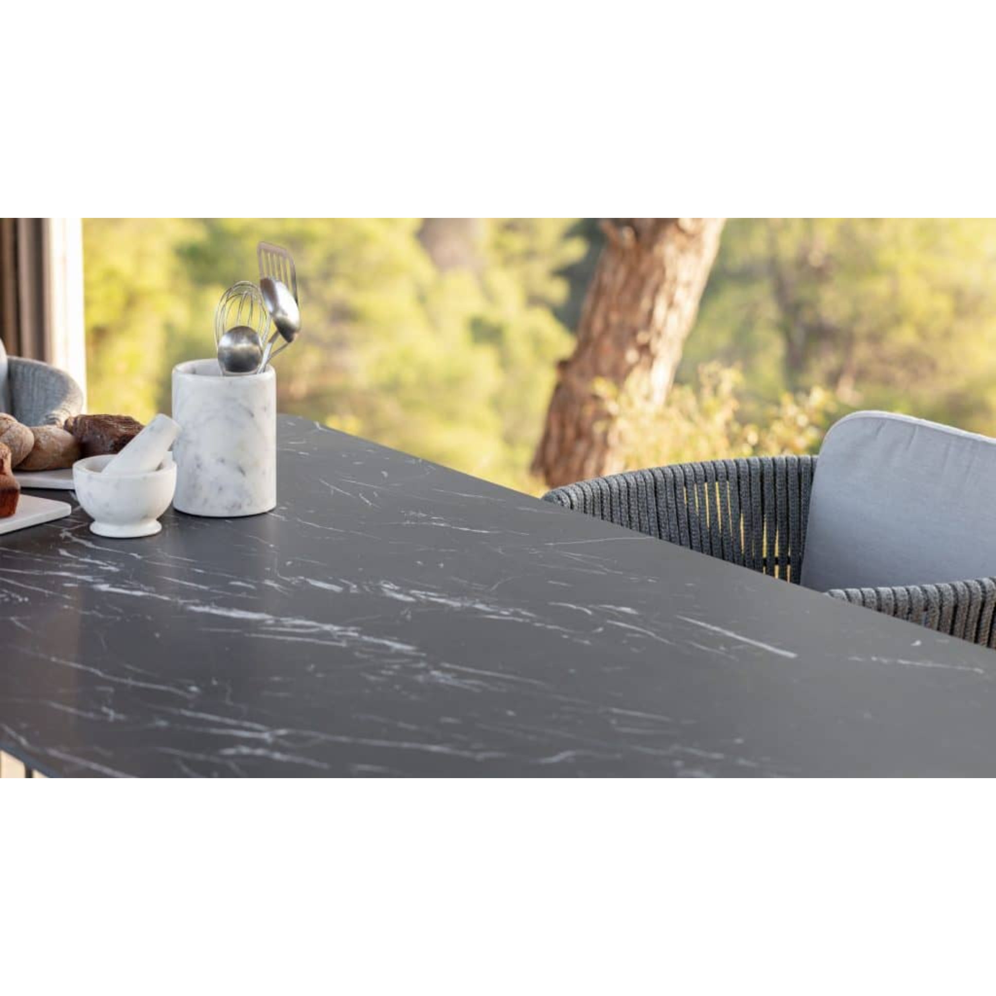 Skyline Design Boston outdoor 7-piece dining set with rectangular carbon aluminum table and six matching chairs.