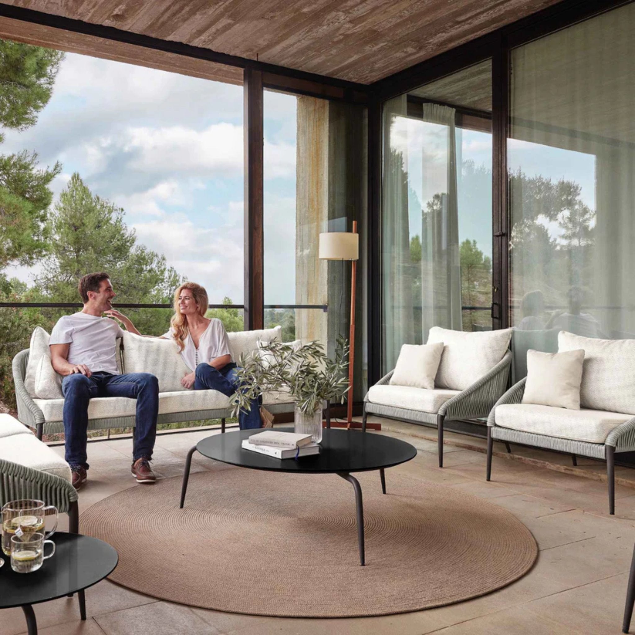 Skyline Design Rodona outdoor lounge set with sofa, chairs, and coffee table in black and brown wicker for stylish outdoor seating.