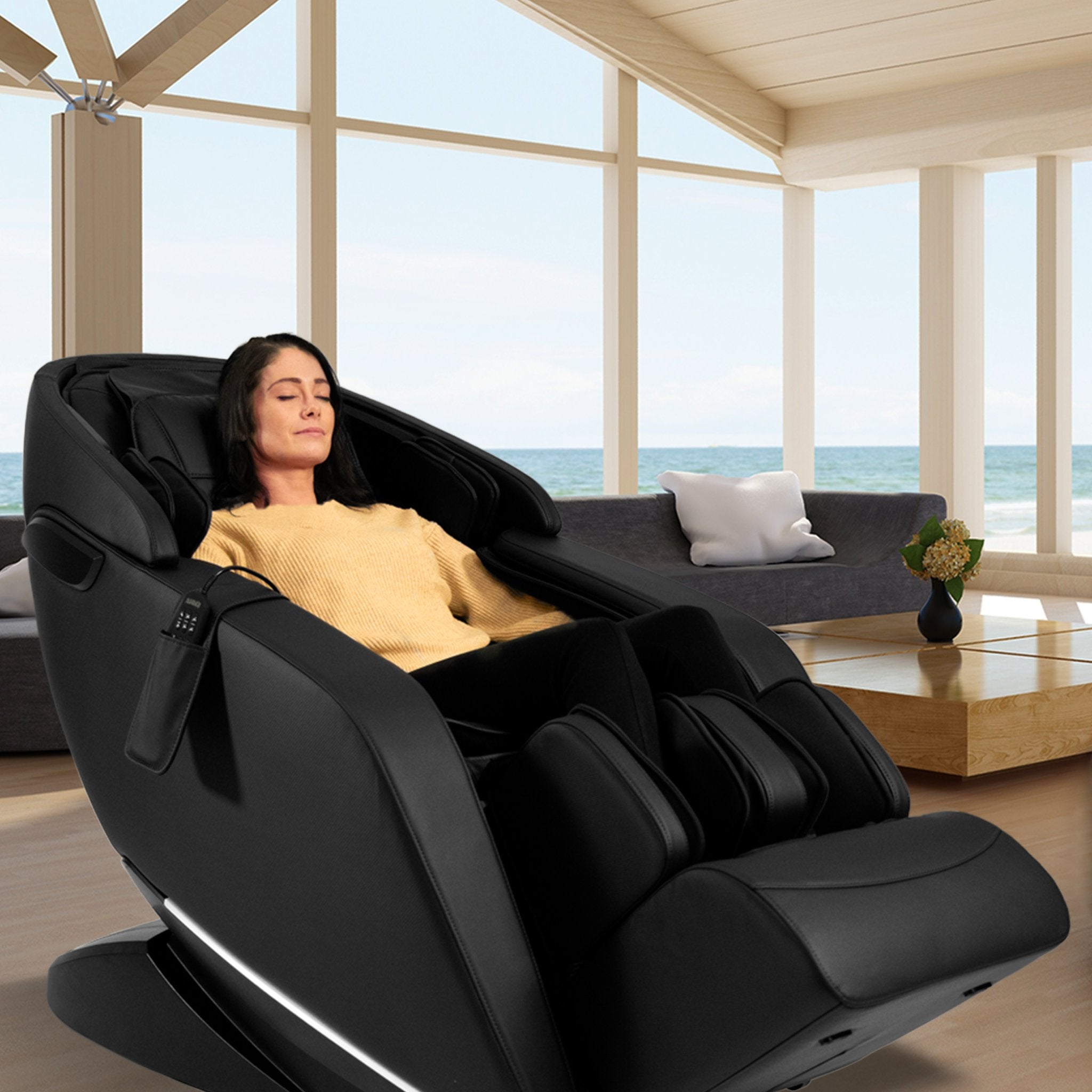 Kyota Genki M380 black full body zero gravity massage chair with ergonomic design in a modern living room setting