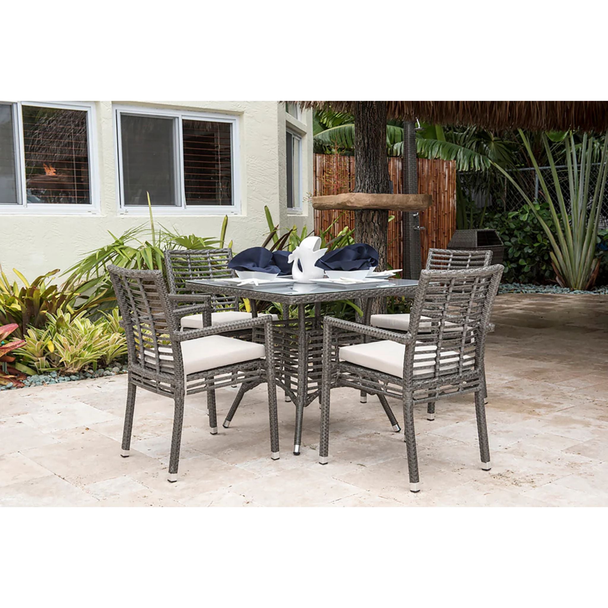 Panama Jack Outdoor Graphite 5-piece square armchair outdoor dining set with cushions, table, and chairs for patio dining.