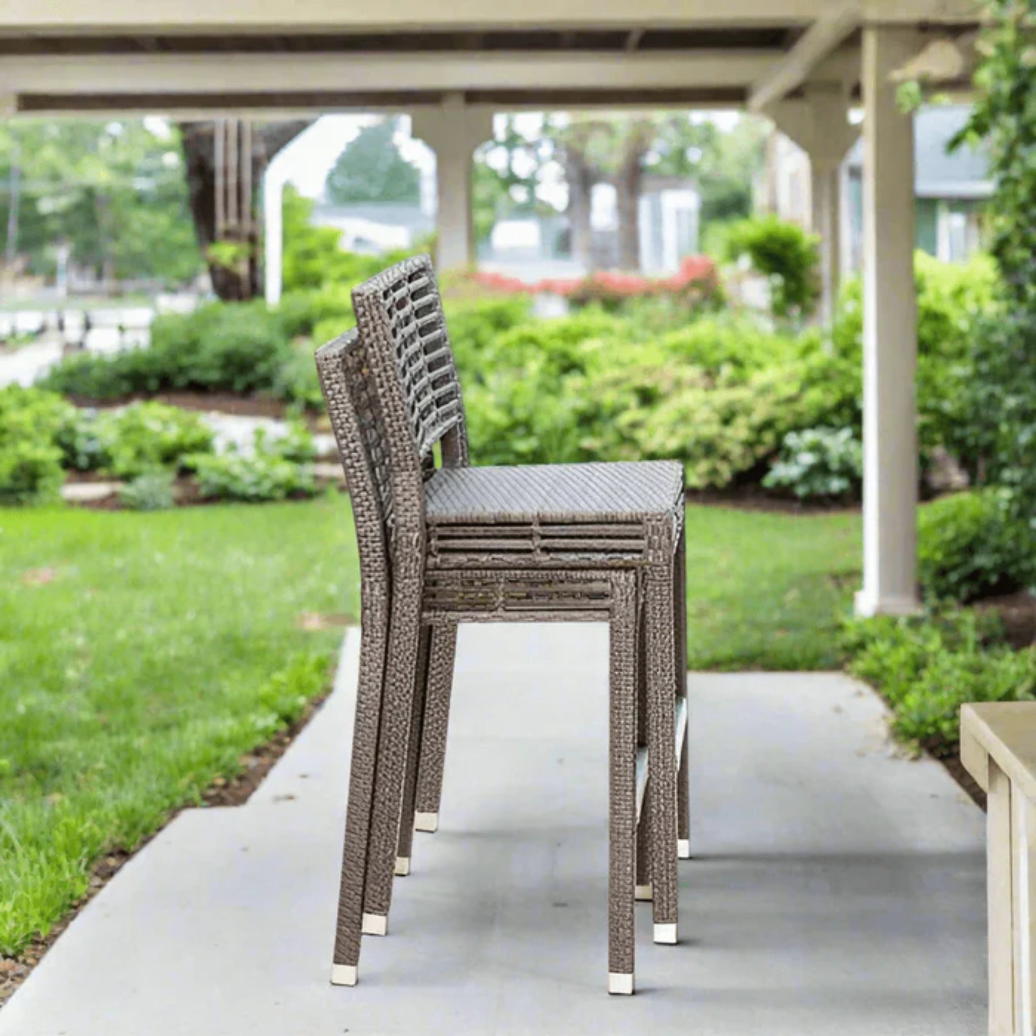 Panama Jack Outdoor Graphite 3-piece outdoor bar set with cushioned stools and a table, ideal for patio entertaining.