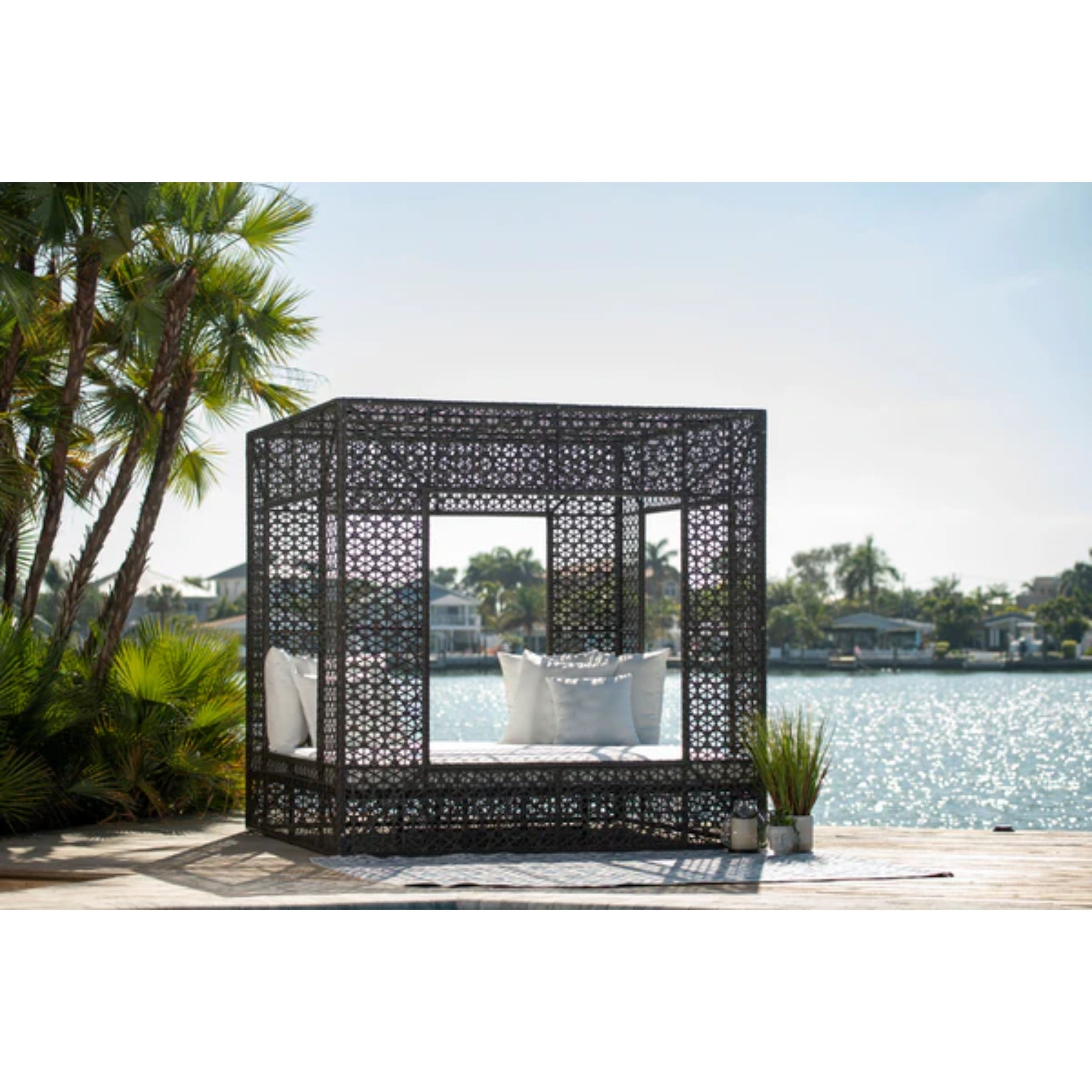Panama Jack Outdoor Serenity Square Outdoor Daybed with wicker frame and plush cushions, perfect for luxury patio relaxation.