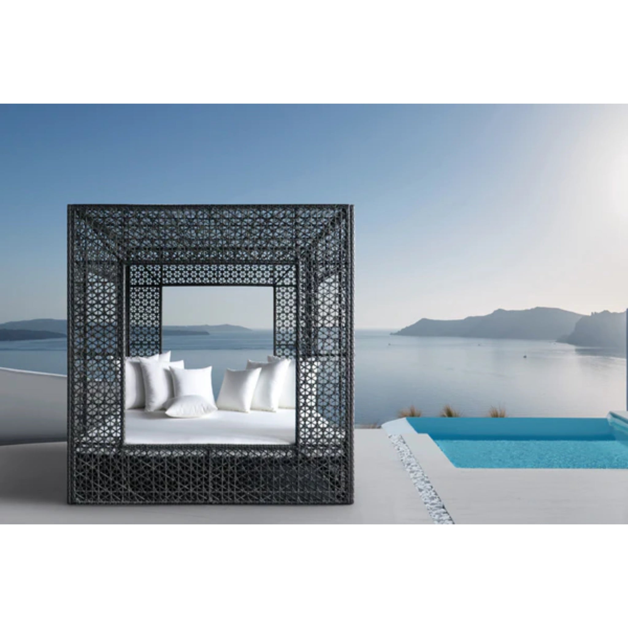 Panama Jack Outdoor Serenity Square Outdoor Daybed with wicker frame and plush cushions for luxury patio relaxation.