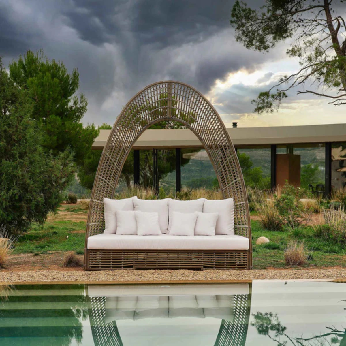 Skyline Design Ruby outdoor daybed with woven fiber in mushroom finish, featuring plush cushions for outdoor lounging.
