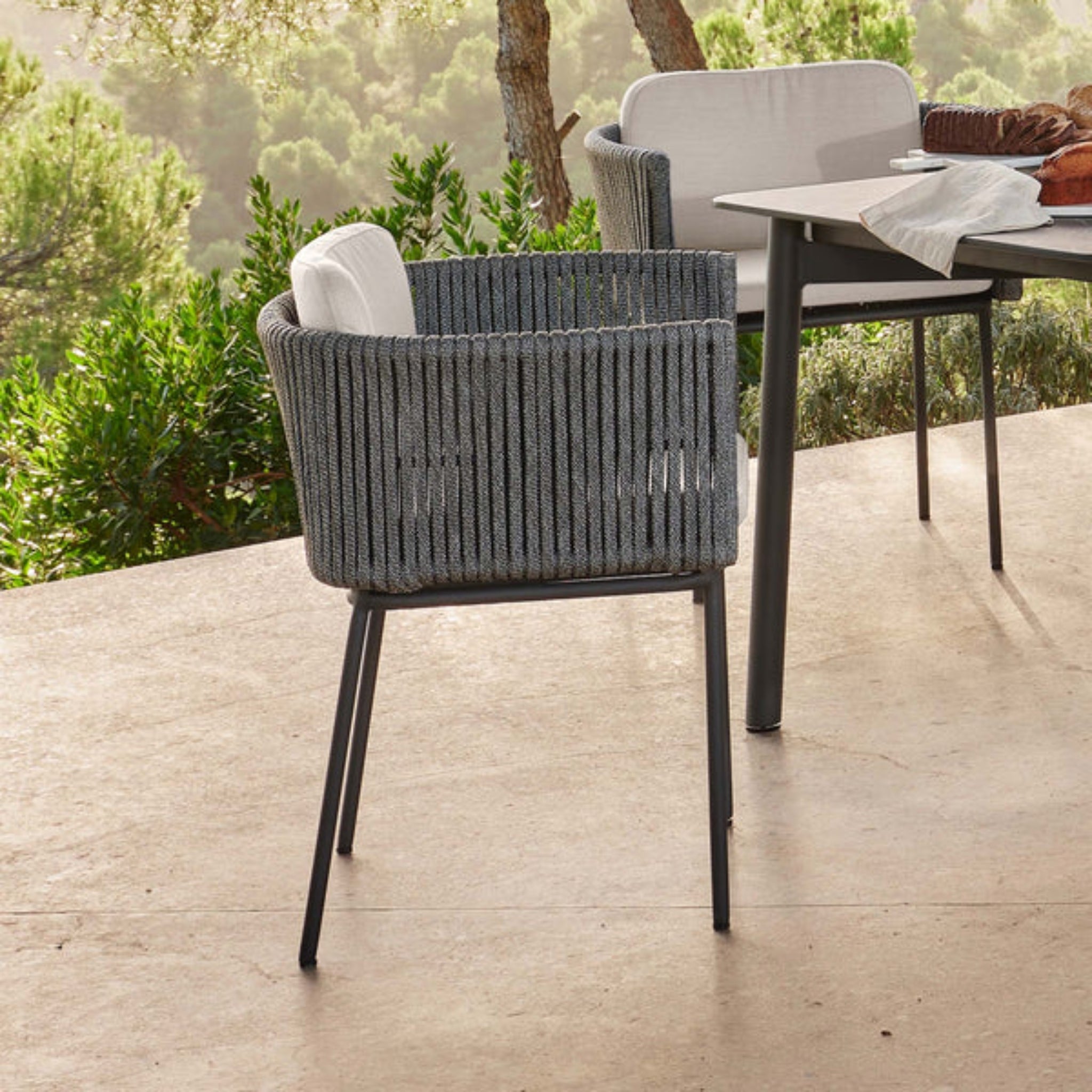 Skyline Design Boston outdoor lounge set with light grey woven armchair, sofa, and tables for stylish outdoor relaxation.
