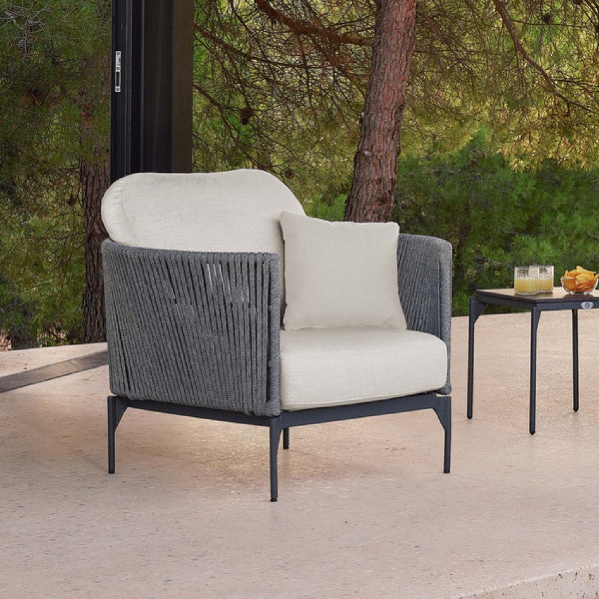 Skyline Design Boston outdoor lounge chair with light grey strap weave and armrests, ideal for patio relaxation.