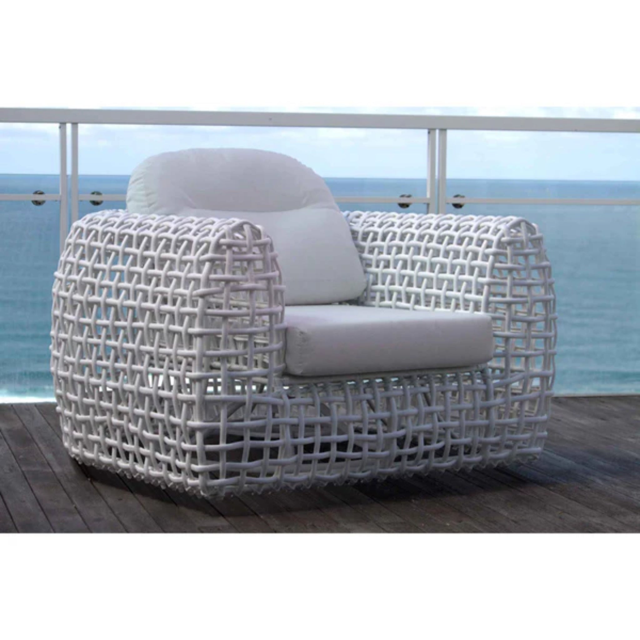 Skyline Design Dynasty outdoor lounge chair with mushroom-colored woven fiber for patio relaxation, featuring a comfortable armchair design.