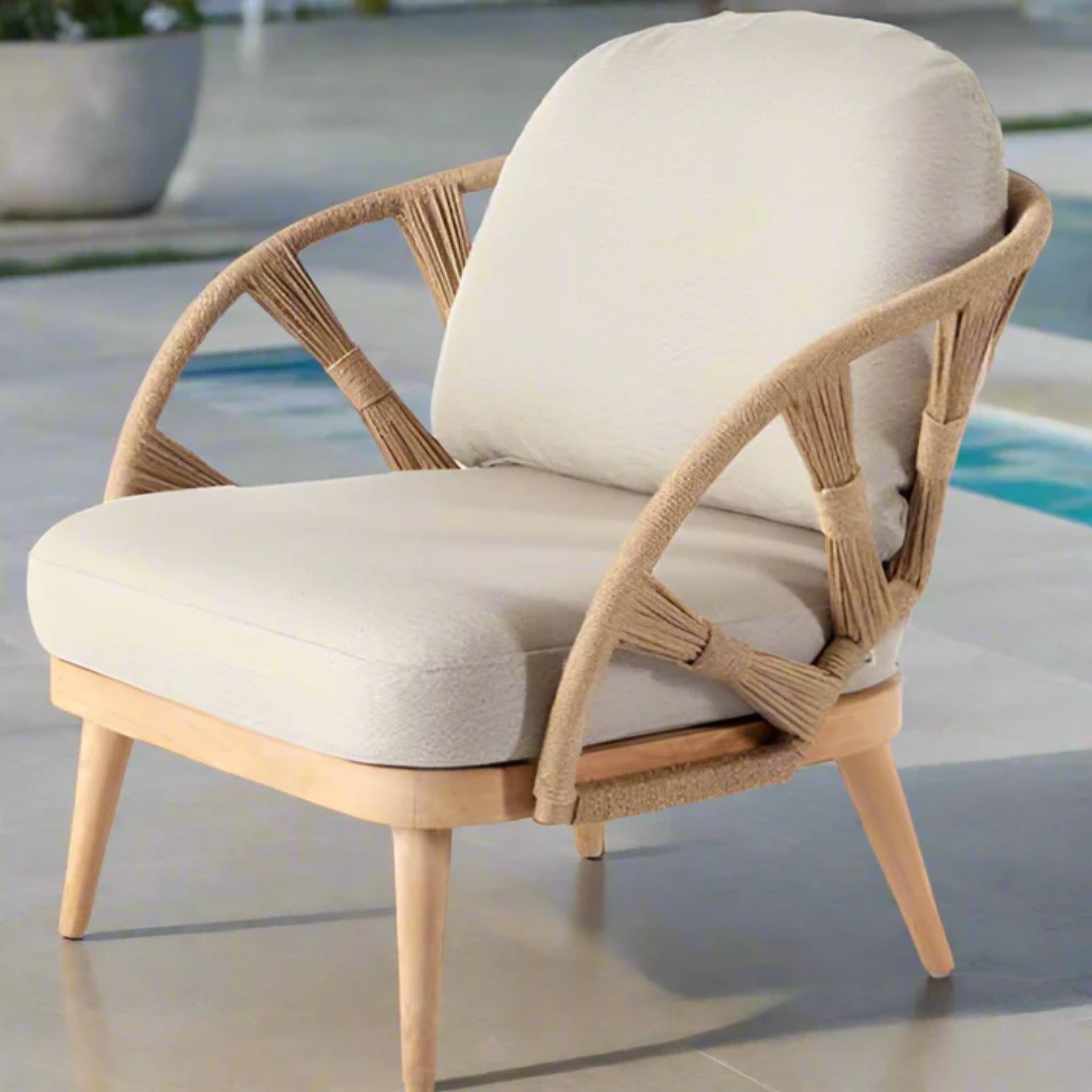 Skyline Design Krabi outdoor lounge chair with natural rope and teak armrests, perfect for patio relaxation and outdoor seating.